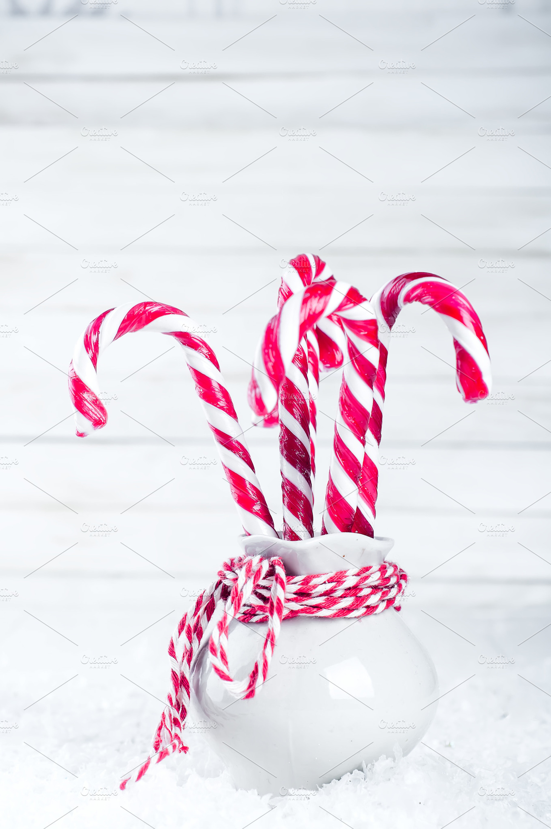 Vase with christmas candy canes containing christmas, candy, and sweet, a Food & Drink Photo by YuMyart