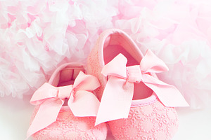 Baby's bootees containing background, concept, and girl