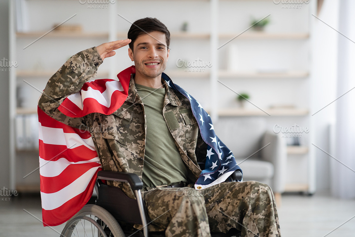 Patriotic veteran sitting in wheelchair with flag of the US, a Photo by Prostock-Studio (Photo 1 of 4)