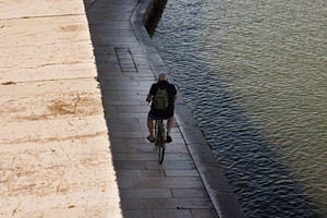 Old man riding bike in Pellestrina Island, a Transportation Photo by Bepslabor