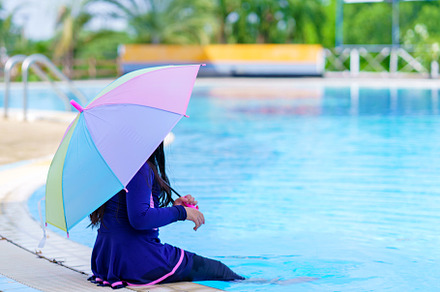 little girl smiling near in swimming pool and holding colourful, a Sports & Recreation Photo by Casanowe-studio