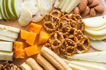 Delicious cheese mix with grapes, jam, snacks, crackers, walnuts, a Food & Drink Photo by vimart