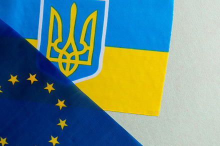 European union and Ukraine two folded silk flags together