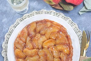 Apple Tart Tartin on plate, french upside down cake, vertical top view, a Food & Drink Photo by iuliia_n