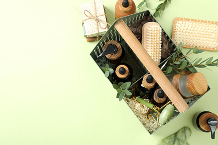 Concept of gift with basket of cosmetics on green background, a Beauty & Fashion Photo by AtlasStudio PRO