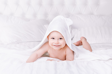 Adorably baby lie on white towel in bed happy childhood and healthcare, a Person Photo by fotoliza