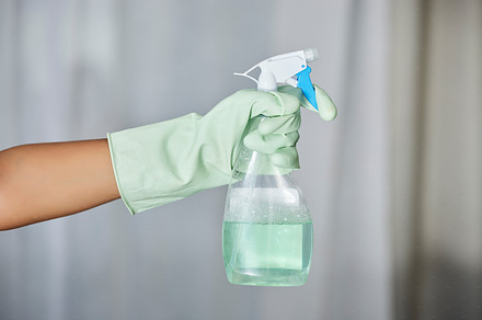 Spray bottle, detergent and maid with gloves for cleaning in a house, office or apartment. Hygiene, cleaner service and hand of a housekeeper with liquid for housework or sanitize dust, dirt or germs, a Photo by Peopleimages.com