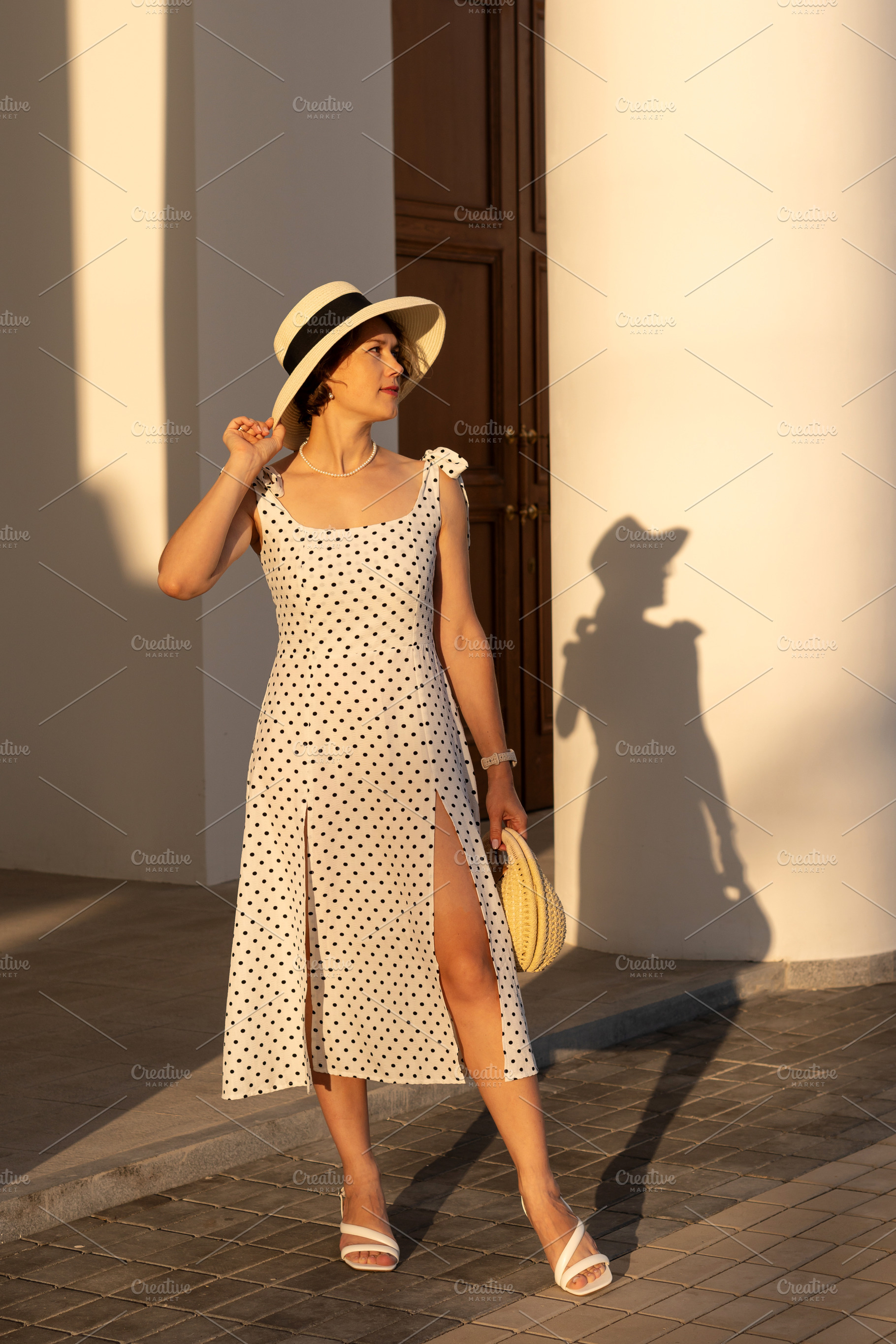 Woman in Polka‑Dot Dress Holds Hat, a Person Photo by Elena Vagengeim