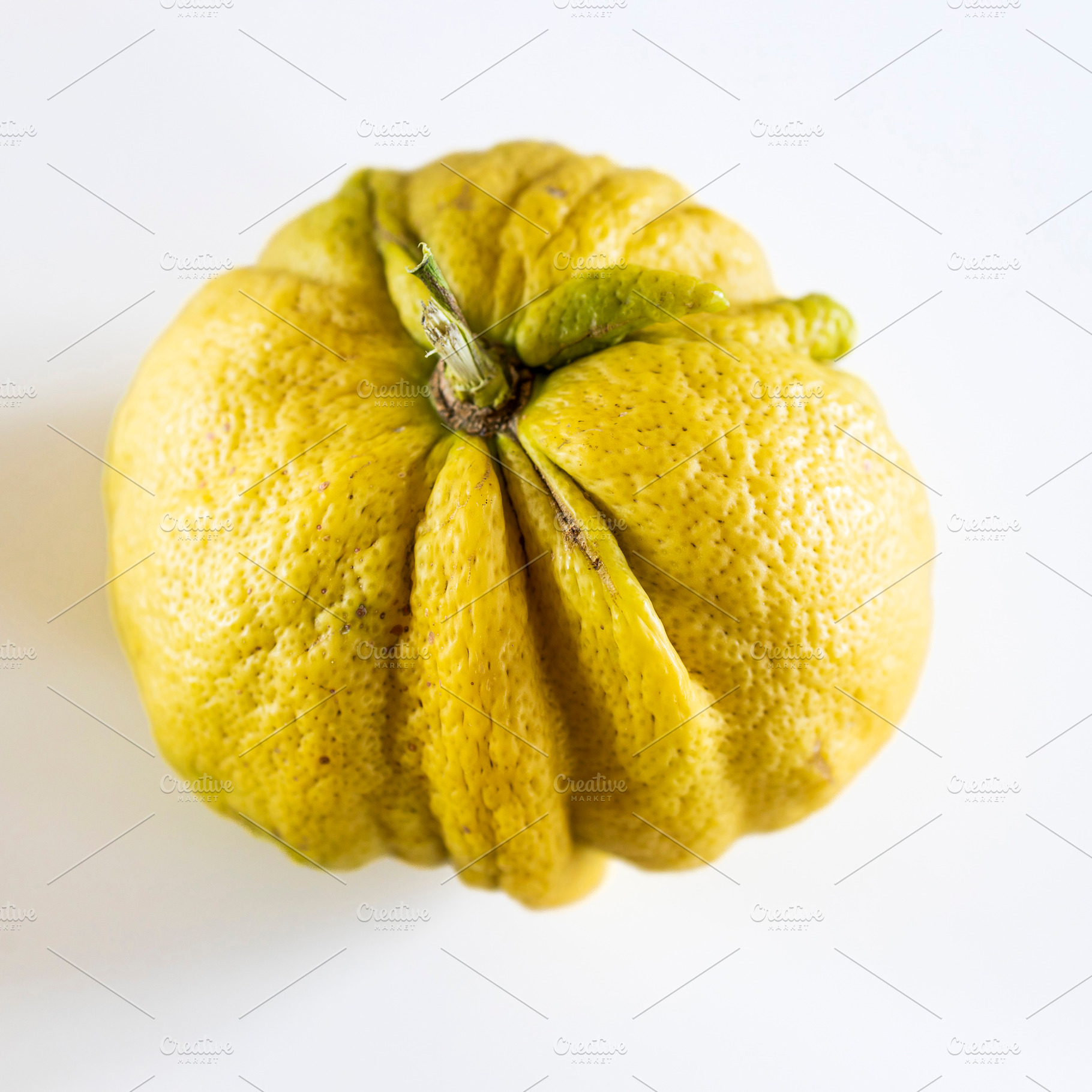 Close-up of a wrinkled yellow citrus, a Food & Drink Photo by Imaginarium