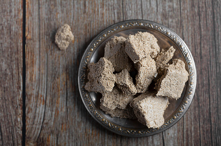Vegetable-based halva sweet prepared from seeds on wooden background, a Food & Drink Photo by zakiroff