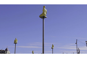 Golden statues sitting on poles, an Architecture Photo by Media Whale Stock