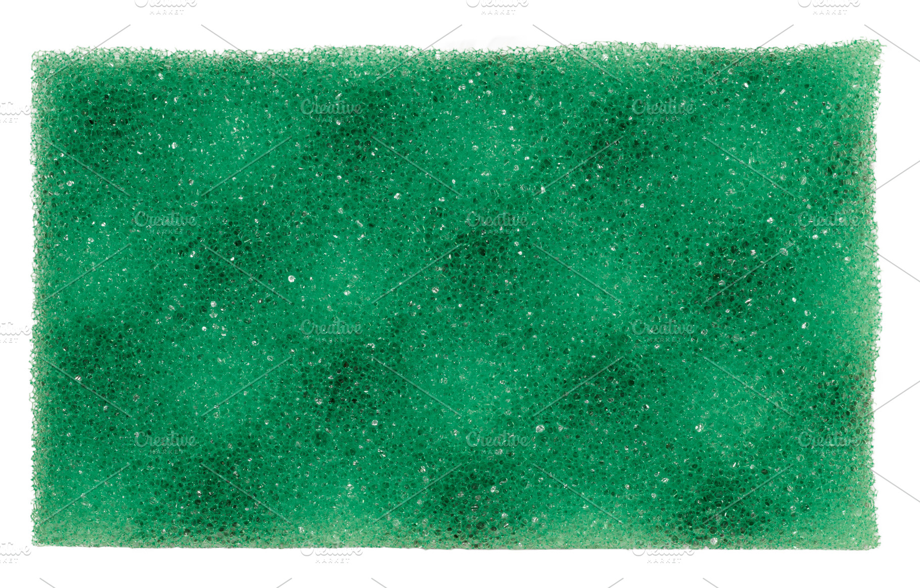 Rectangular piece of green porous sponge on isolated background, an Abstract Photo by ndanko