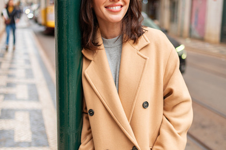 Happy caucasian girl walking city street on sunny autumn day, a Person Photo by andreonegin market