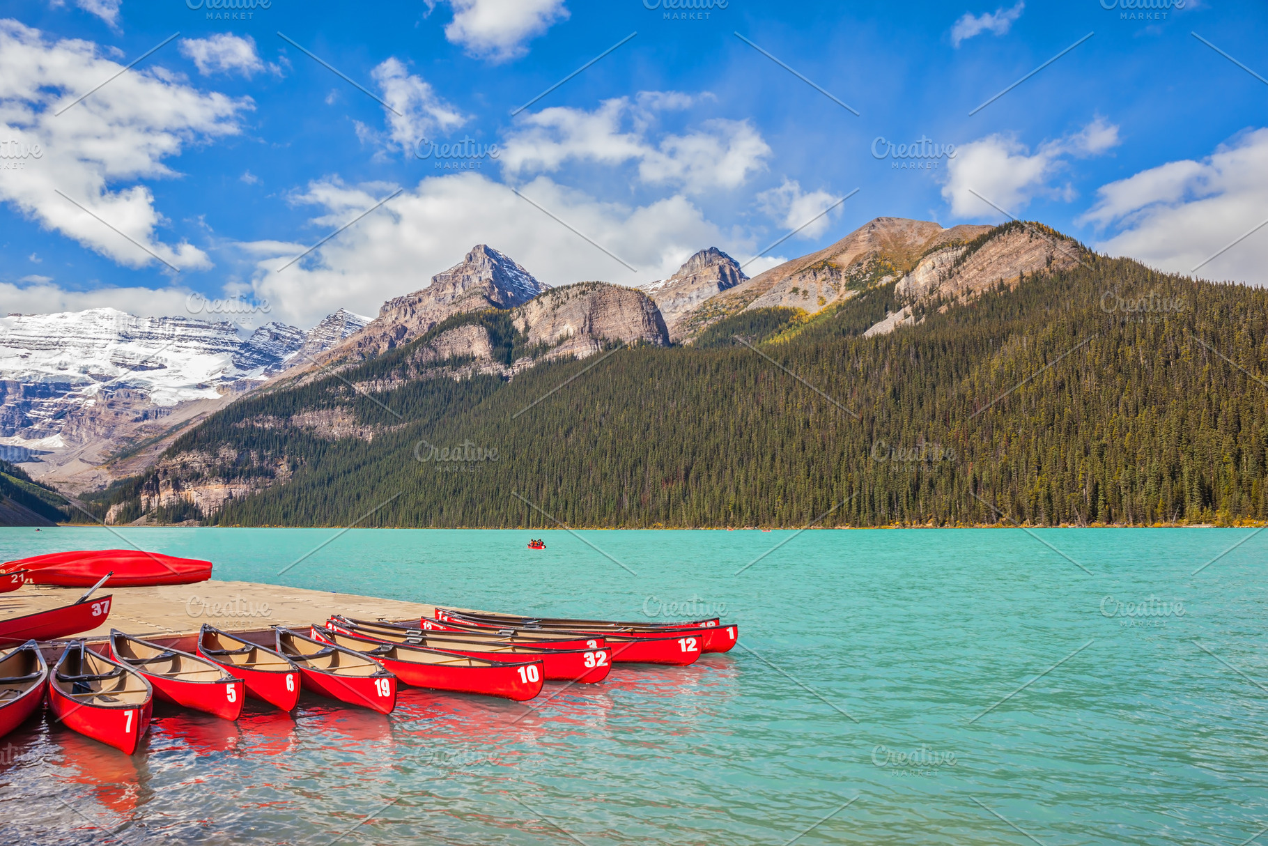 Lake Louise  is surrounded by mountains, glaciers and pine fores, a Nature Photo by kavram