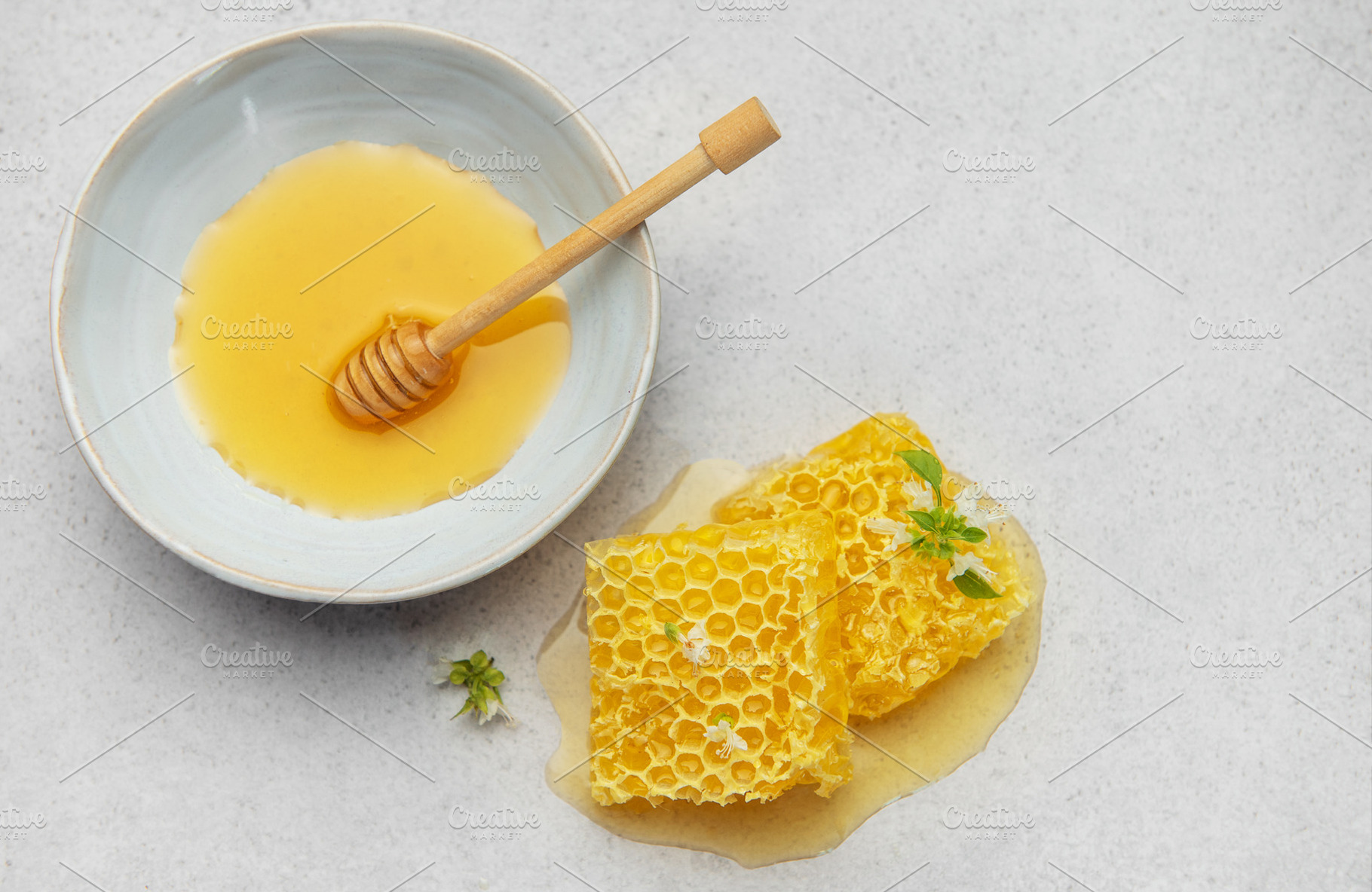 Honeycomb, honey dipper and bowl of honey on kitchen table, a Food & Drink Photo by Olena Rudo