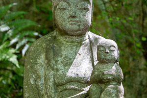 Jizo Bosatsu statue holding baby at Mitaki-Dera in Hiroshima, a Nature Photo by GoodGoods