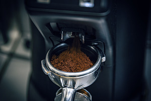 Coffee machine grinding coffee beans, a Photo by Grafvision photography