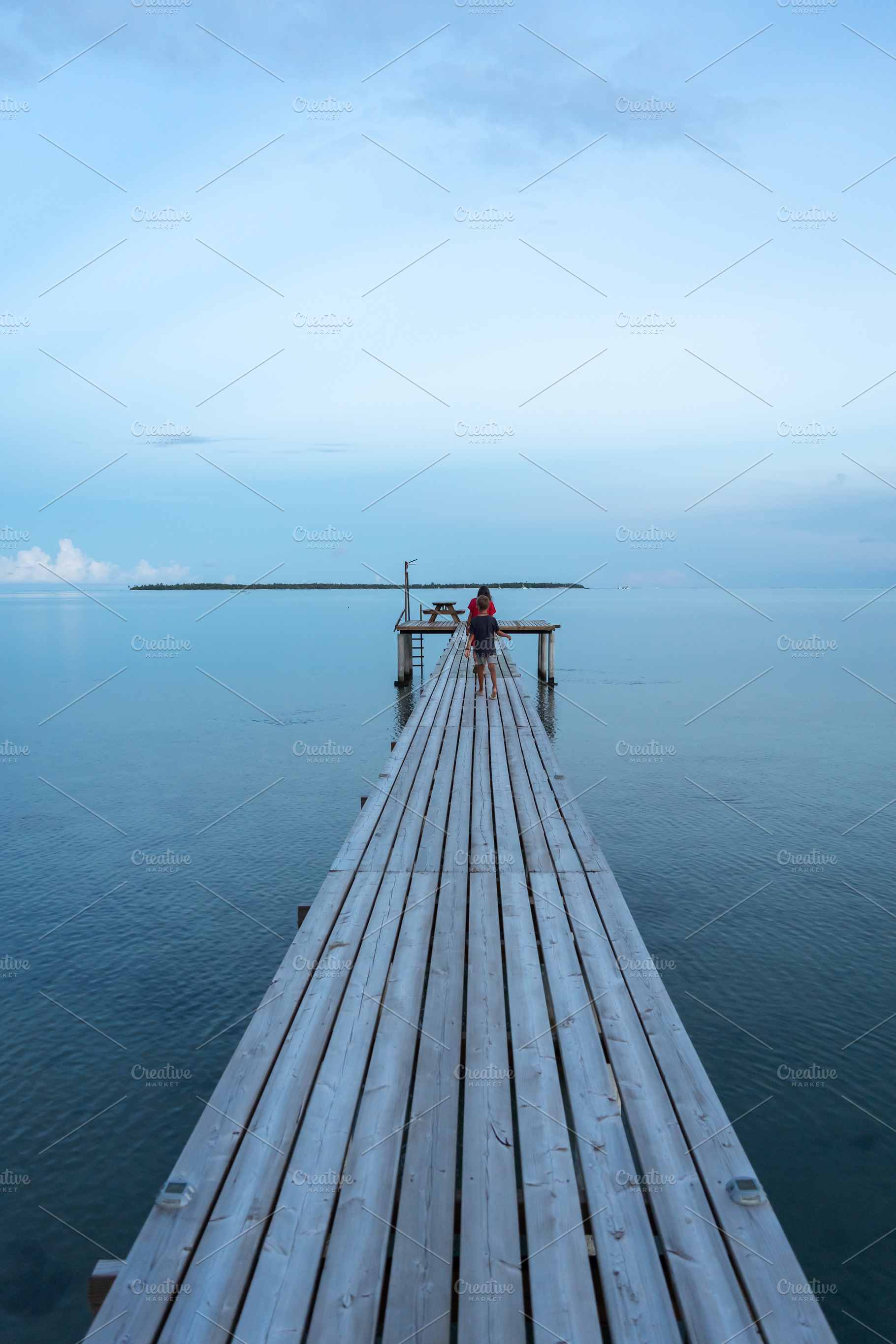 Sunrise on the wooden pier of Maupiti beach, French Polynesia, a Nature Photo by GoodGoods