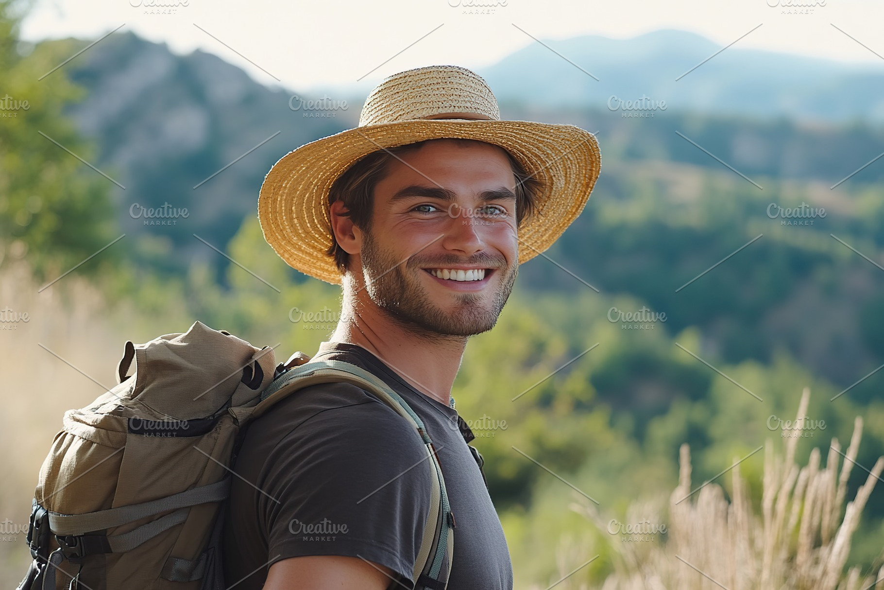 Smiling athletic man in straw hat enjoying outdoor adventure at scenic mountain, a Person Photo by AlyaAnd