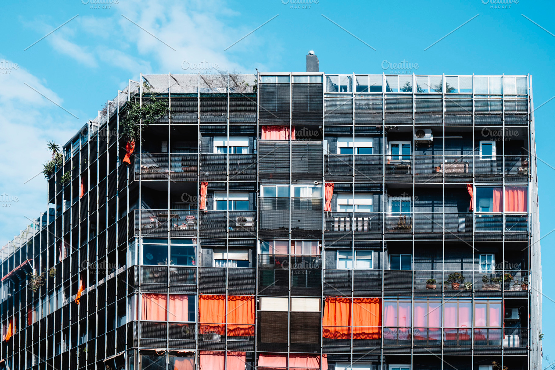 top section of a contemporary apartment block, a Photo by Nito