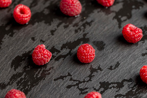 fresh red raspberries on the table, a Photo by rsoollAI