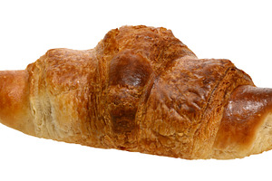 Baked crispy croissant on isolated background, a Food & Drink Photo by ndanko
