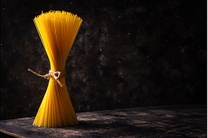 Raw uncooked sspaghetti on dark, a Food & Drink Photo by Yulia Furman