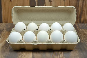 Fresh white eggs in carton box, a Food & Drink Photo by AlyaAnd