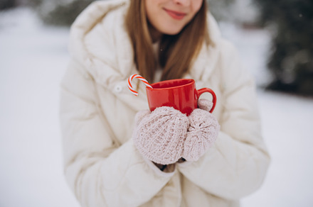Cute happy woman holding hot coffee, a Holiday Photo by Cherkas Photography