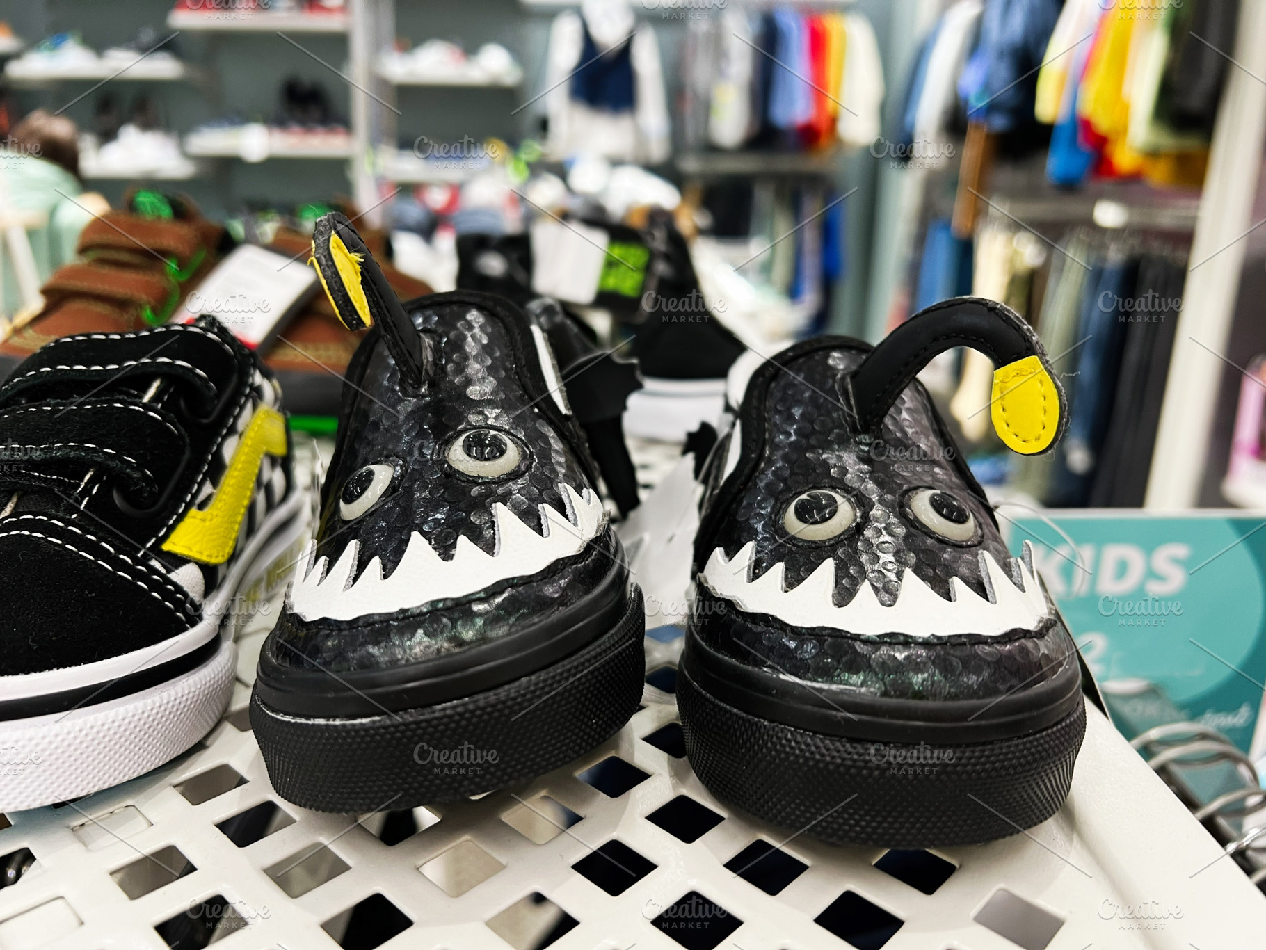 Colorful stylish children's shoes displayed on shelf in a retail clothing store, a Photo by AS photostudio