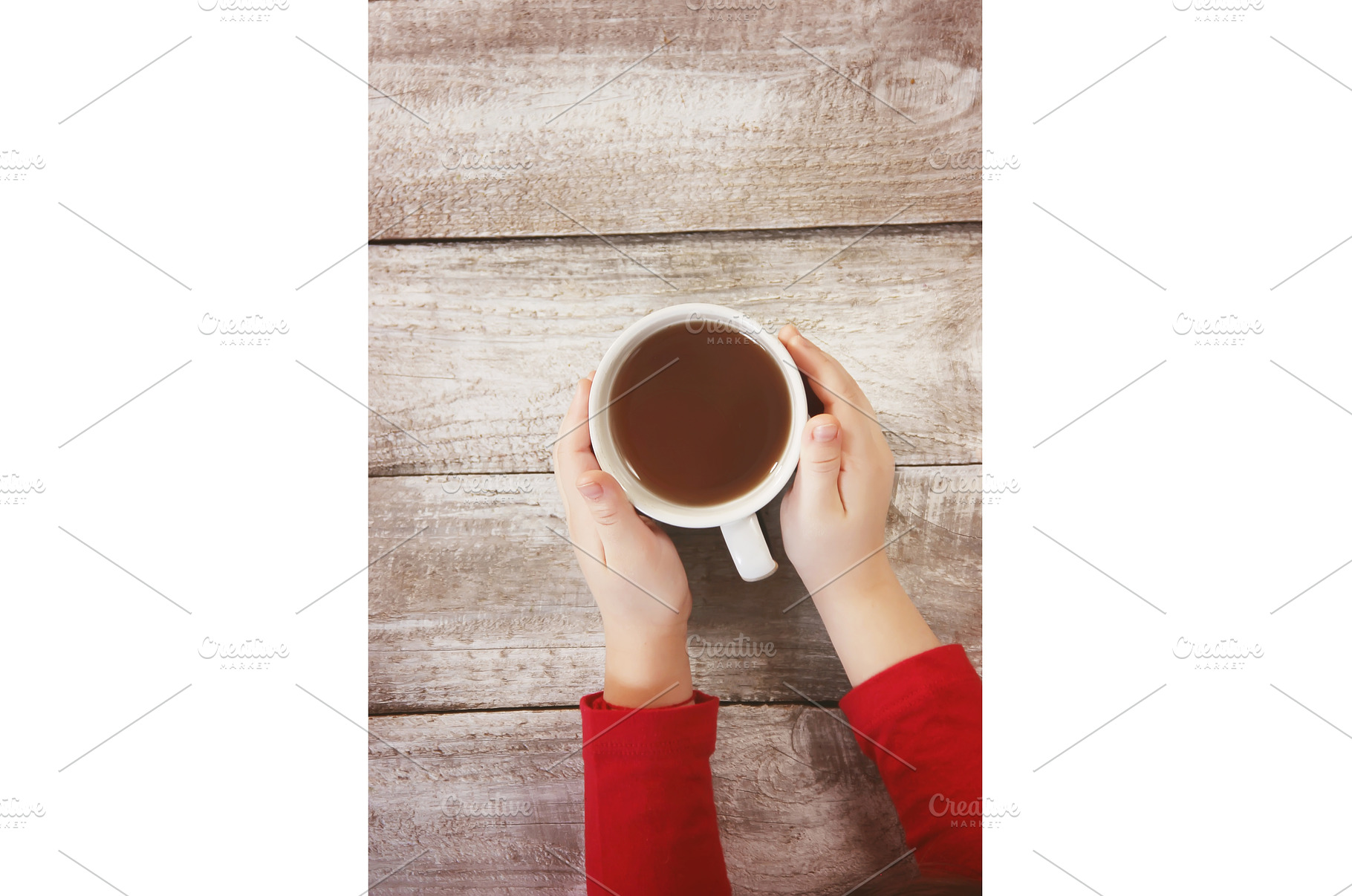 A cup of tea in the hands of a child, a Food & Drink Photo by yanadjana