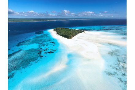 Aerial view of blue sea and Mnemba, a Nature Photo by den-belitsky