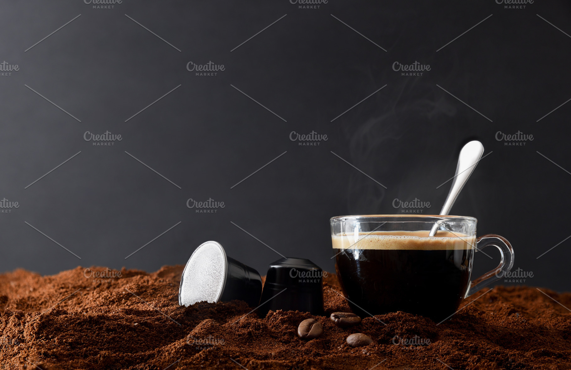 Glass cup of espresso on ground coffee and capsules front, a Food & Drink Photo by Davizro's Market