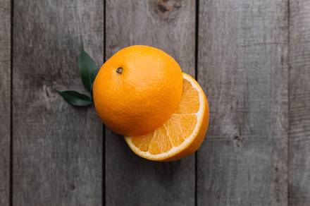 Halves of orange fruit on gray, a Food & Drink Photo by Lenor4ik