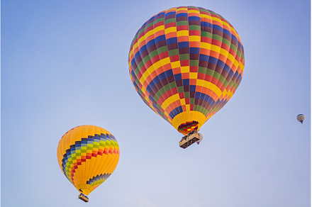 Beautiful hot air balloons over blue, a Transportation Photo by Elizaveta Galitskaya