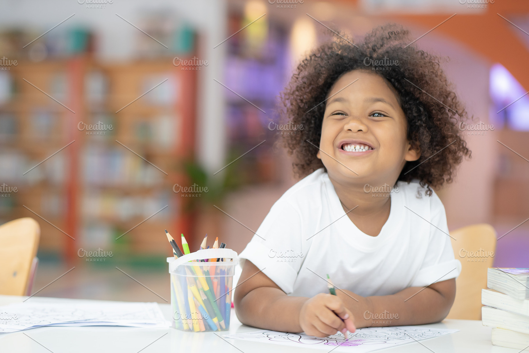 Happy girls are painting in library containing art, drawing, and artist, a Person Photo by Guitarfoto Studio