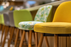 Colorful stools arranged at a bar, a Photo by Beautiful things