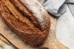Fresh baked rye bread loaf on wooden board, a Food & Drink Photo by Olena Rudo