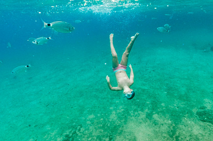Little kid diving on the Mediterranean sea, a Person Photo by Cosca