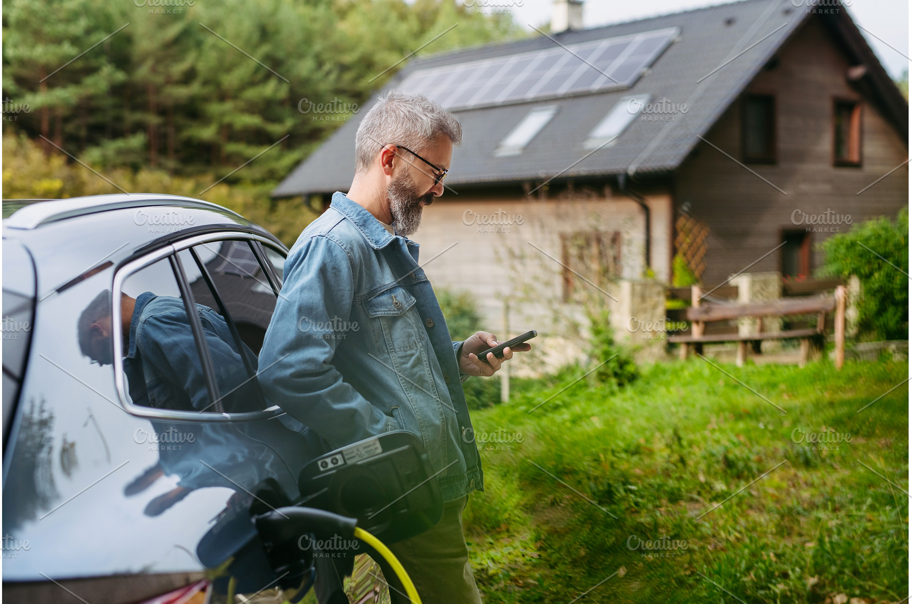 Man charging electric car in front, a Transportation Photo by HalfPoint