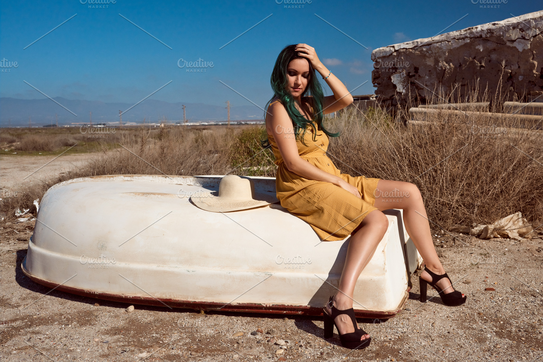 a girl sitting on a boat stranded in a summer landscape, a Beauty & Fashion Photo by YossSabalet
