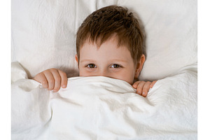 Young boy in bed before going to, a Person Photo by Fascinadora