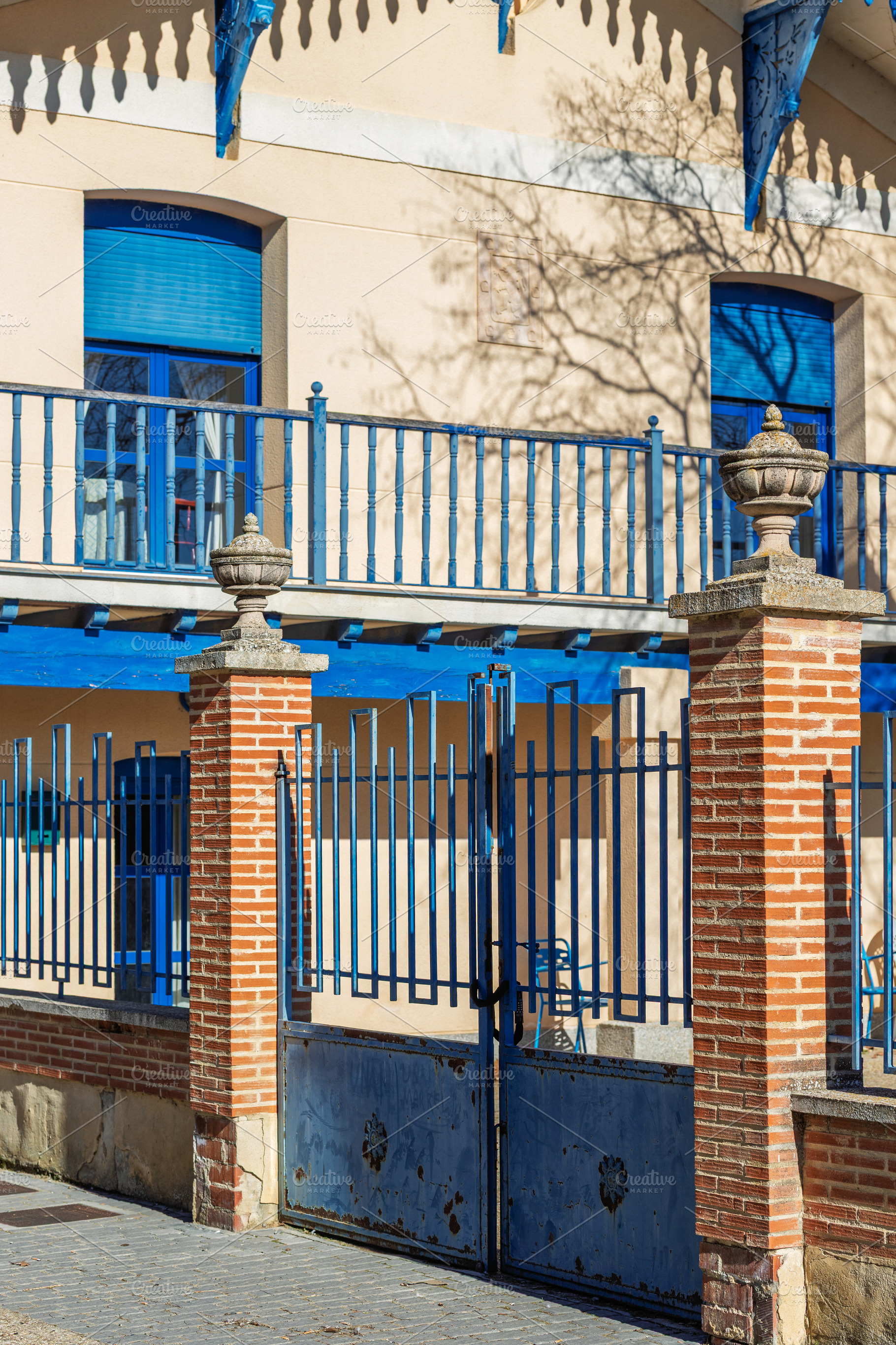 Building facade with blue railings a, an Architecture Photo by Perpis