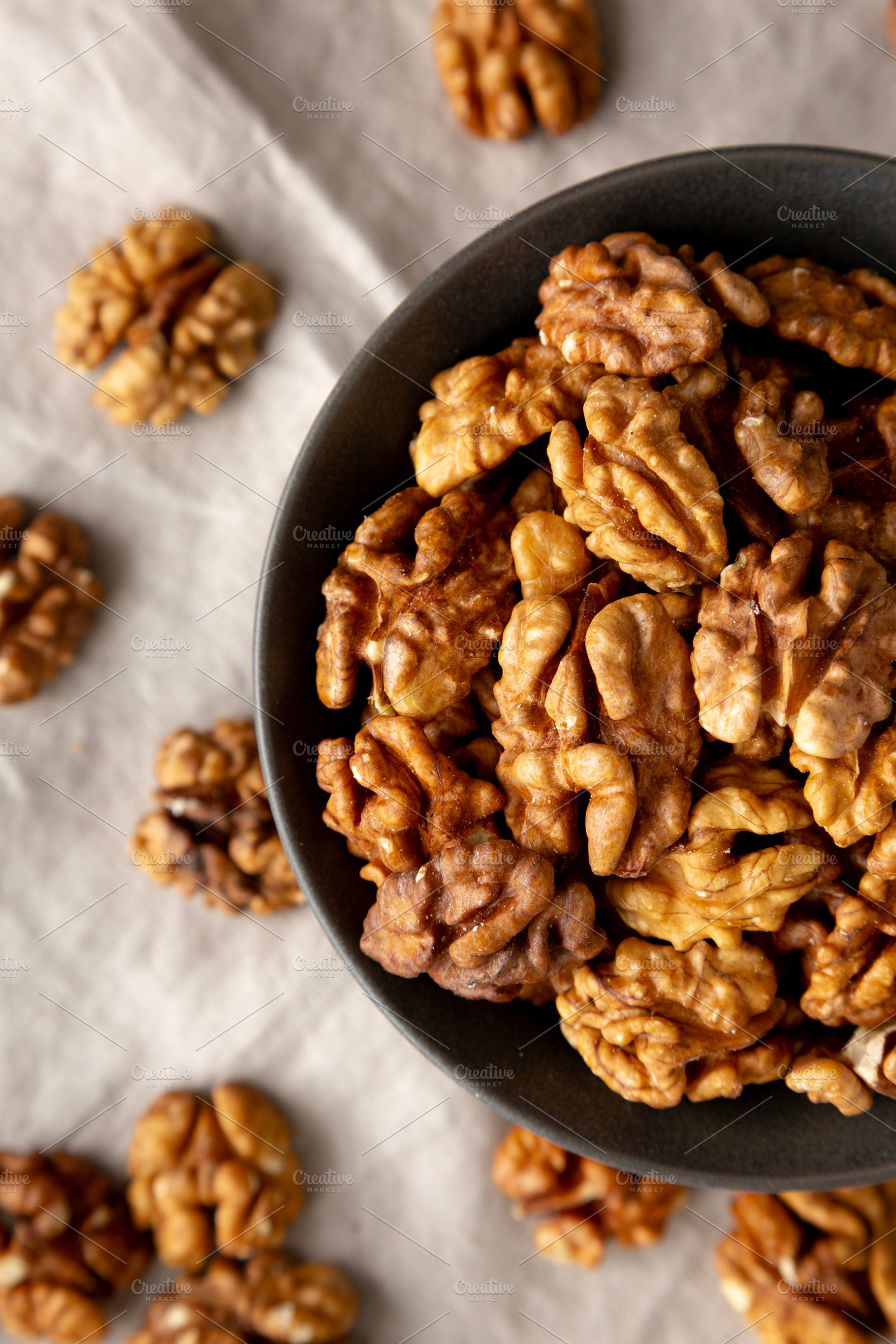 Raw Walnut Halfs in a Bowl, top view. Flat lay, overhead. Close-, a Food & Drink Photo by LiudmylaChuhunova