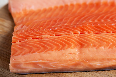 Organic Raw Salmon Fillet on a wooden board, side view., a Food & Drink Photo by LiudmylaChuhunova