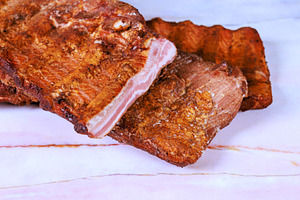 Grilled pork ribs resting on marble, a Food & Drink Photo by Ungvar Studio