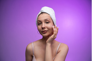 Young woman applying face cream, a Health & Medical Photo by volodymyrshtun13795