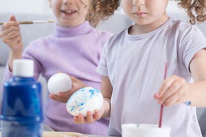 Two sisters decorating Easter eggs., a Person Photo by etorres69