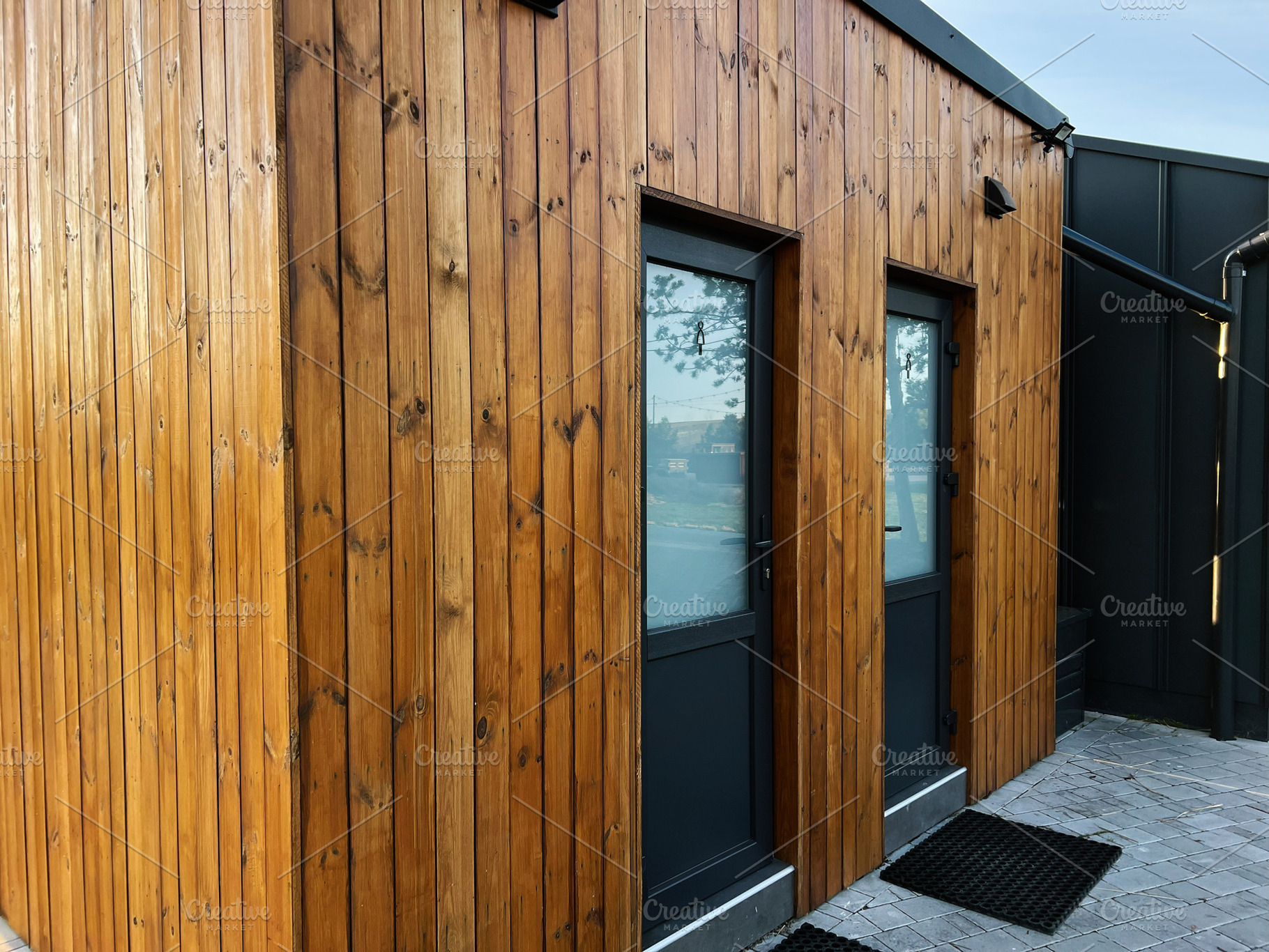 Wooden building WC facade with glass doors and modern design under daylight, a Photo by AS photostudio