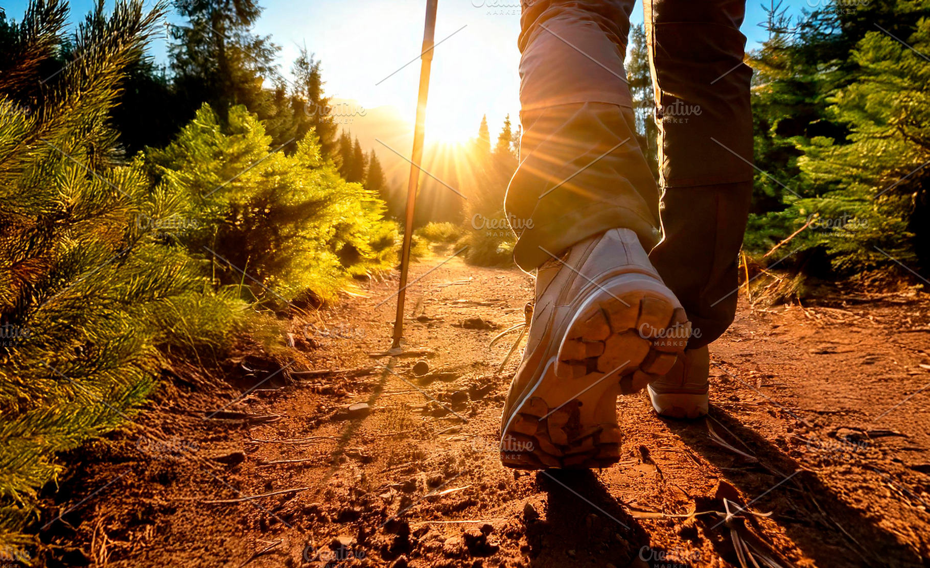 Legs of a mountaineer walking along path with evening sun, a Sports & Recreation Photo by Davizro's Market